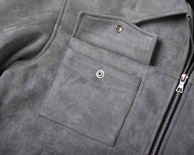 Close-up of Hipok Brand grey suede jacket showing snap button pocket and zipper detail