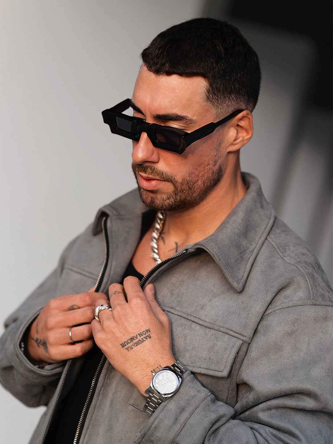Man wearing Grey Suede Jacket by Hipok Brand with silver watch and black sunglasses