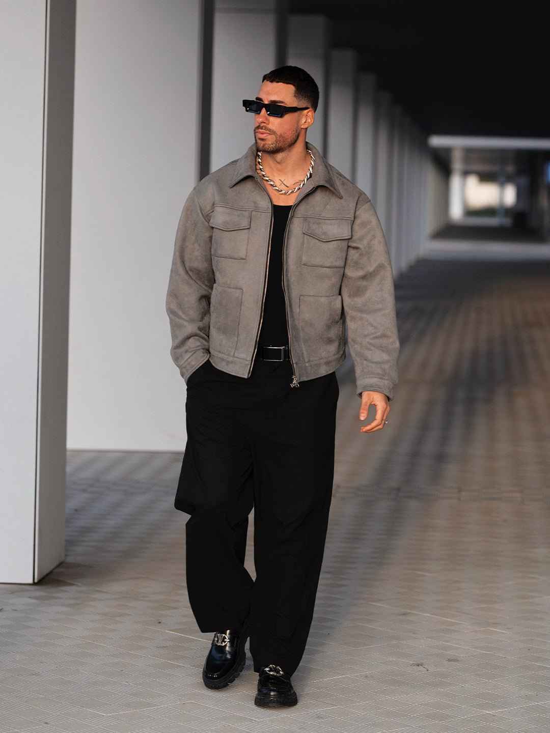 Hipok Brand Grey Suede Jacket worn by a man with black pants and sunglasses walking outdoors